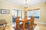 The dining room has sliding doors onto a large deck with outdoor dining space and BBQ grill.